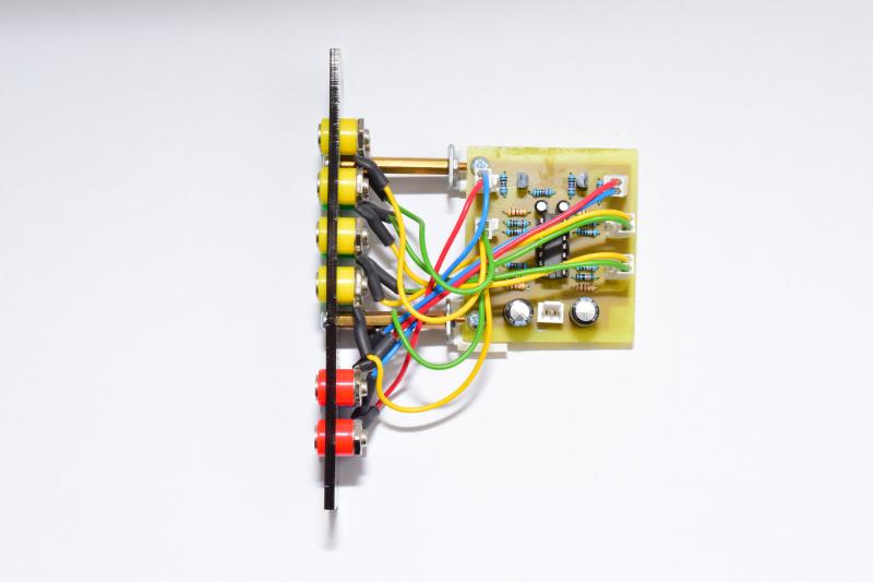 Side view of inverters module, showing the home-etched PCB and wiring A single chip is socketed in the centre.