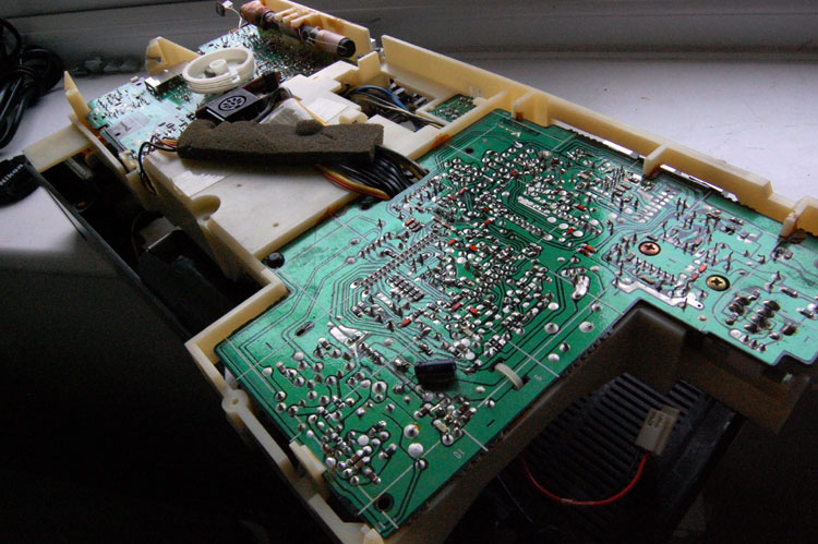 Angled photo of the backside of the radio, with the case removed; shows the soldered side of the PCBs, as well as the internal part of the radio antenna and some wiring